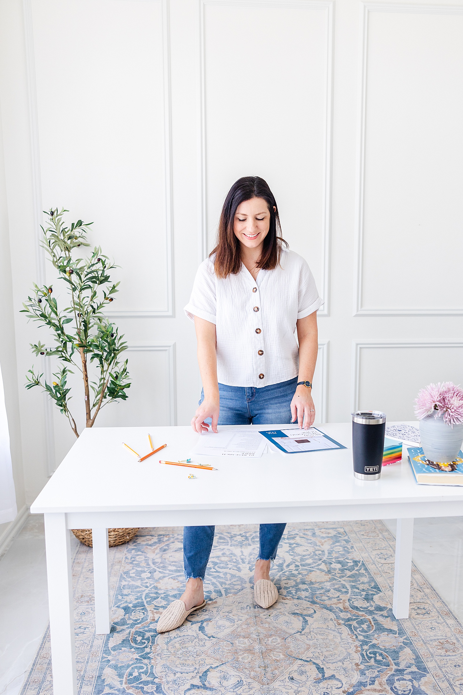 Showit website copywriter Dianna of Rise Copy Co standing at a desk